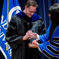Kevin Lehnert receives his award from President Mantella